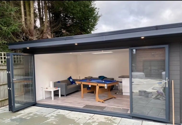 Large outdoor building with open bifold doors.
