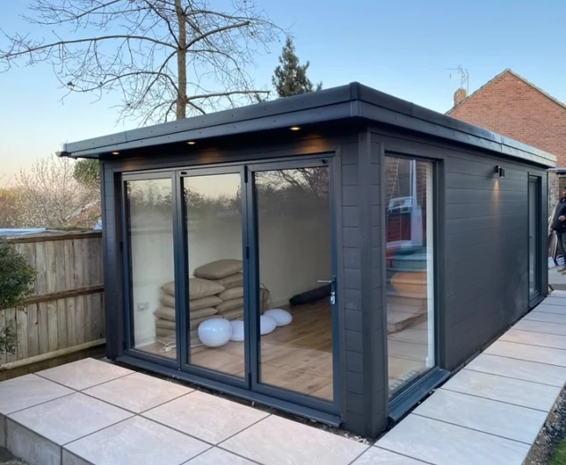Black outdoor office on paving slabs.